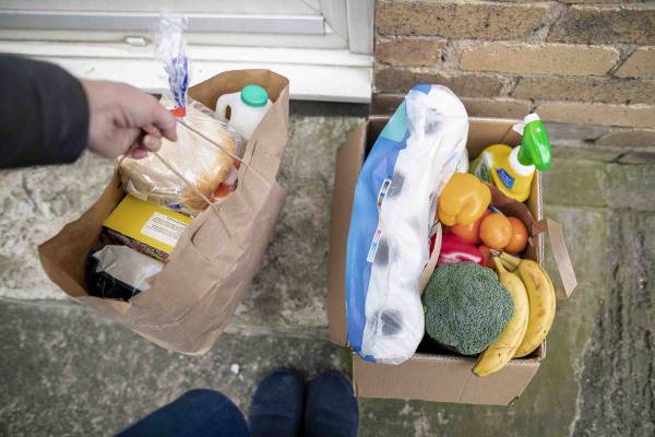 Groceries being dropped off on someones porch