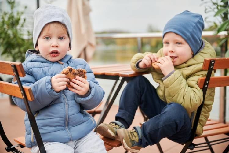 two boys eating cookies