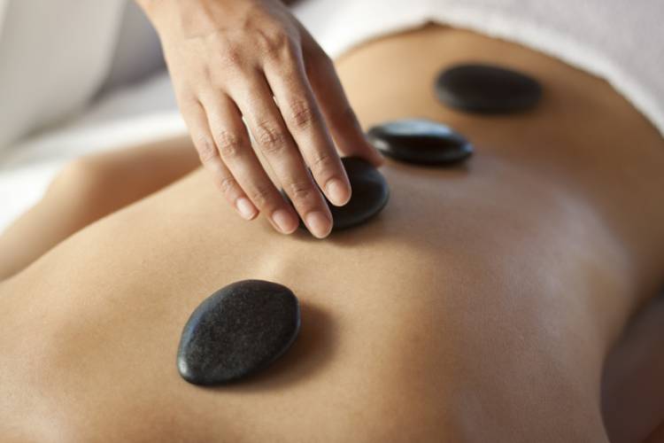 A person getting a stone massage