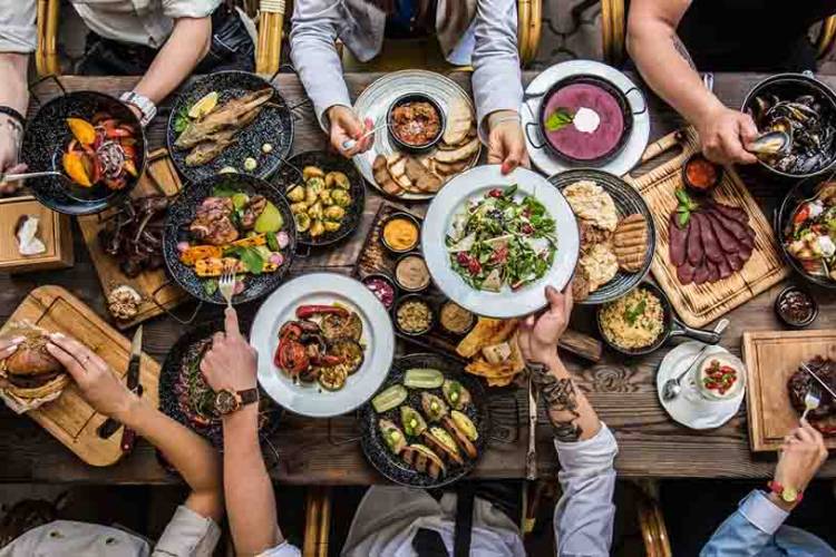 Family sitting around a big table enjoying a meal