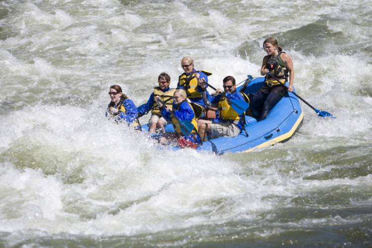 Friends on a white water raft in Colorado