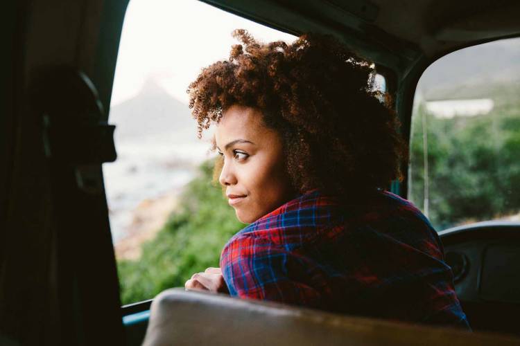 Woman looking out the window of a taxi