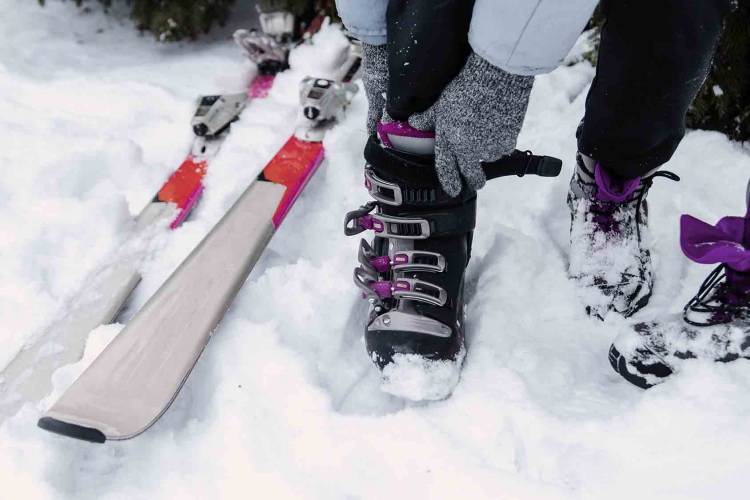 Woman putting on ski boots