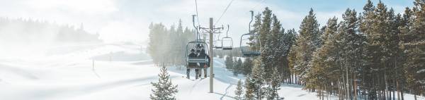 Skiers sitting on a chair lift