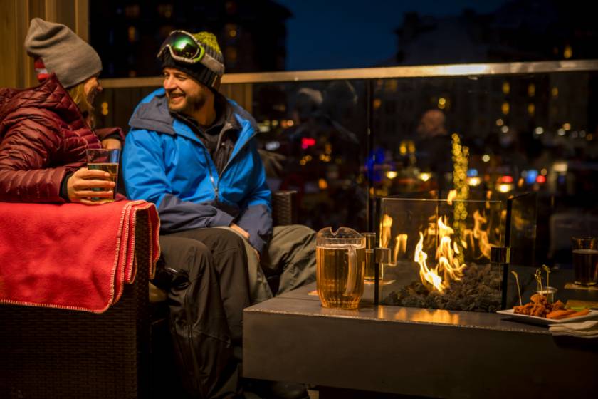 A couple sitting and enjoying apres ski drinks